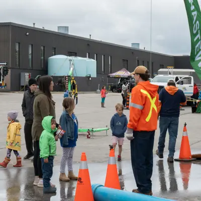 Public works employee talking to children