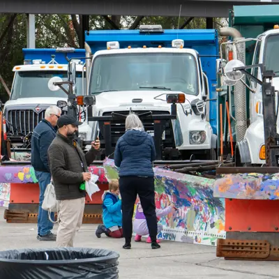 Families viewing the snowplow trucks