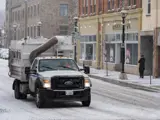 City salt truck going down the wintery road.