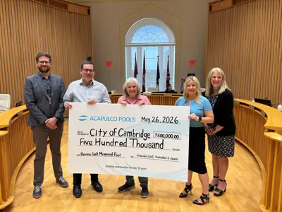 City staff, the Mayor, and company representatives holding a large cheque for a sponsorship donation.