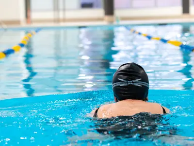 Person swimming in pool.