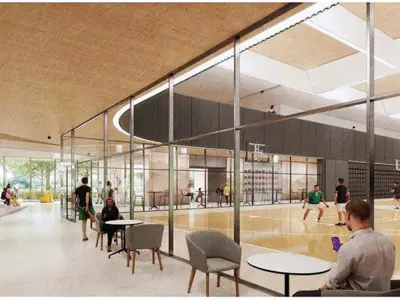 Architectural rendering of the Cambridge Recreation Centre gymnasium viewing area. A glass-walled multi-sport gym with hardwood courts is viewed from a bright public lounge space featuring tables, chairs, and seating areas. Large windows, wood-accented ceilings, and open gathering spaces provide clear sightlines into the gym while creating a modern, community-focused atmosphere.